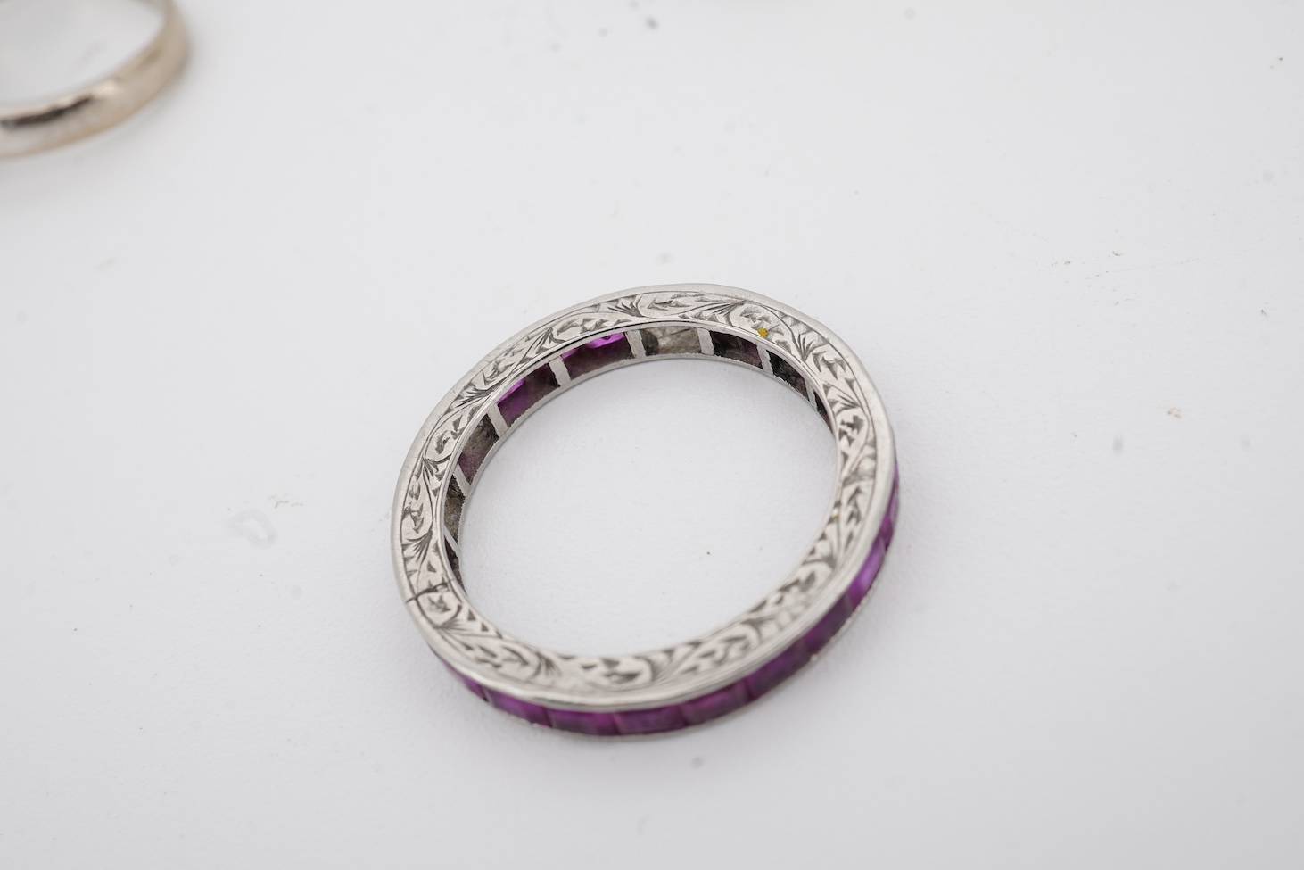 A yellow metal and illusion set three stone diamond crossover ring, size I, an 18ct, sapphire and diamond chip set ring, a modern 18ct gold and six stone sapphire set ring, with diamond chip border and an engraved white
